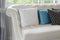 White and blue pillows on a white leather couch in vintage living room