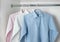White, blue and pink clean ironed men\'s shirts hanging on hanger