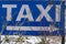 White and blue taxi sign