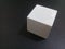 White blue-tooth wireless cube speaker on black background with copy space