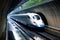 A white and blue train is seen traveling at high speed through a dark tunnel, Bullet train passing through a tunnel in Japan, AI