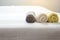 White,Blue,Yellow towel on bed,Stack of plush hotel towels