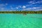 White boat on azure water among exotic palm trees