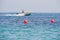 White boat and orange floats in blue sea