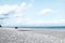 White boat on the pebble beach. Tourist season on the mediterranean sea. Sicily. Ionian sea. Minimalism in nature.