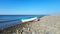 A white boat on the seashore, on a sunny day, against a blue sky