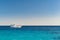 white boat with tourists in azure sea