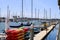 White boats and yachts at the docks in the harbor with deep blue ocean water and blue sky at Burton Chace Park