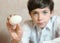 White boiled egg in boys hand
