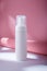 White bottle with dispenser mockup on pink backdrop in harsh light, no brand template. Cleansing facial foam container with paper