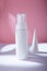 White bottle with dispenser mockup on pink backdrop, no brand template. Cleansing foam container with concrete decorative elements