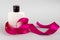 White bottle with pink ribbon. Body cosmetics. Gift with ribbon. Shampoo. The hairdresser
