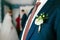 White boutonniere pinned to a grooms jacket. Wedding preparation