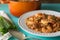 White bowl on a blue table filled with homemade etouffee with shrimp and Andouille sausage.