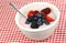 White bowl with cherry yogurt