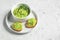 A white bowl and crostini with guacamole