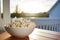 a white bowl filled with air-popped popcorn placed on a sunny veranda