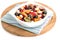 In a white bowl, fruity delicious fresh salad pieces for a healthy breakfast snack.