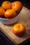 white bowl with lots of delicious tangerines