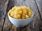 White bowl of macaroni on wooden background