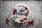 White bowl for a newborn photo shoot decorated with a gray cloth with red roses