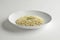 White bowl with parmesan risotto and chives