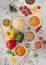 White bowl plates with boiled long grain basmati rice with vegetables and mushrooms on light table background with sticks and