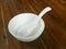 White bowl and spoon ceramic on a wooden background