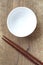 White bowl and wood chopsticks