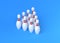 White bowling pins in form of triangle on blue background. orthographic view