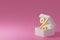White box with gold percentage sale on pastel pink background bank 3d illustration