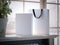 White box and shopping bag on a window sill. 3d rendering