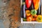 White box with vegetables on a rusty background. Aubergines, bell pepper, tomatoes. Overhead view and copy space.