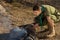 White Boy Scout Making Fire for Cooking at Camp