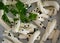 White braided cheese with black sesame served in a white plate