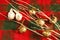 White branch, gold jingle bells, two dove birds, CHRISTMAS, red and green cloth,