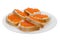 White bread sandwiches with salmon red caviar on glass white plate. Delicious appetizer. Seafood. Expensive delicacy. Isolated on