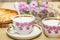 White bread and two teacups on a wooden table