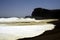 White breakwater foam hit on lonely black lava sand beach at Pacific coastline - Cobquecura Piedra De La Loberia, Chile
