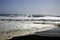 White breakwater foam hit on lonely black lava sand beach at Pacific coastline - Cobquecura Piedra De La Loberia, Chile