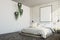 White brick bedroom, poster, plants corner