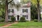 White Brick Georgian Colonial House with Flagpole