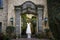 White bride dress hanging in colonial hacienda, rustic weddings