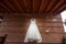 White bride dress hanging in red brick wall colonial hacienda, rustic weddings
