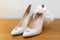 White bride`s shoes, garter and wedding rings