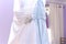 White brides dress hanging against a mirror