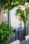 White British brick house with black fence and a balcony