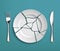 White broken plate with fork and knife