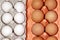 White and brown eggs in package. Chicken eggs in carton cells