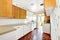 White and brown kitchen interior with tile and floral patterned